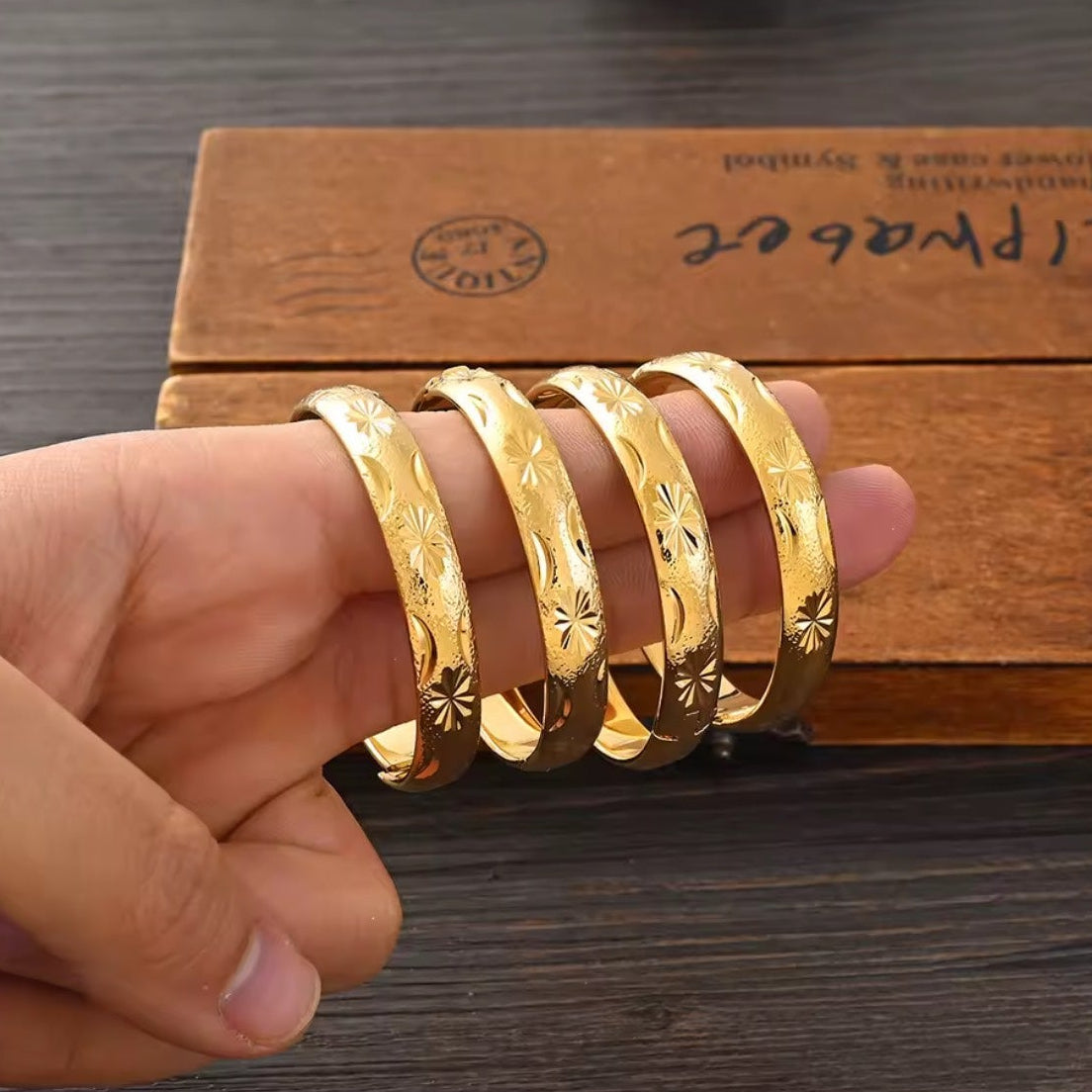 Gold Etched Bangle Set - 4pc held in hand angle 2