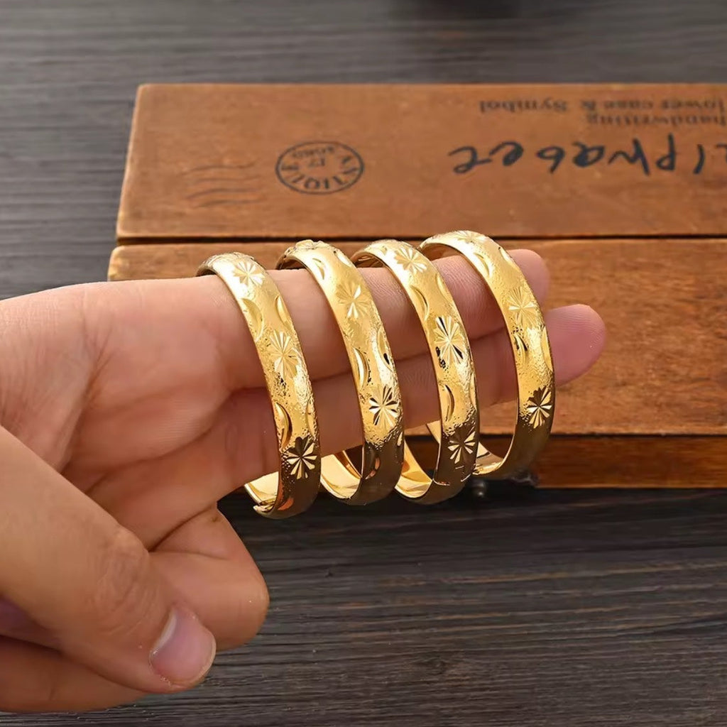 Gold Etched Bangle Set - 4pc held in hand