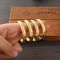 Gold Etched Bangle Set - 4pc held in hand